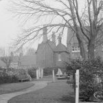 Barking Church of England School, later known as St. Margaret’s Church of England School, Back Lane, Barking, showing approach path with shrubs and posts, and school building in background, 1967