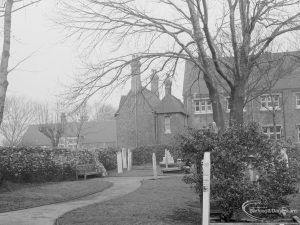 Barking Church of England School, later known as St. Margaret’s Church of England School, Back Lane, Barking, showing approach path with shrubs and posts, and school building in background, 1967