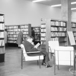 London Borough of Havering Central Library, Romford, showing reader in armchair amongst bookcases, 1967