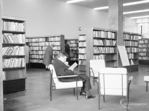 London Borough of Havering Central Library, Romford, showing reader in armchair amongst bookcases, 1967