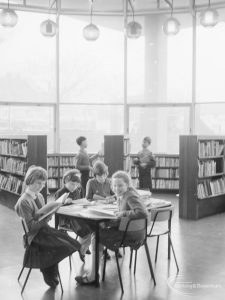 London Borough of Havering Central Library, Romford, showing junior library, with children sitting and reading at table, 1967