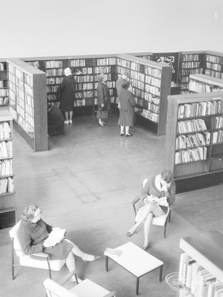 London Borough of Havering Central Library, Romford, showing part of the lending department, with two women resting in armchairs and seen from above, 1967