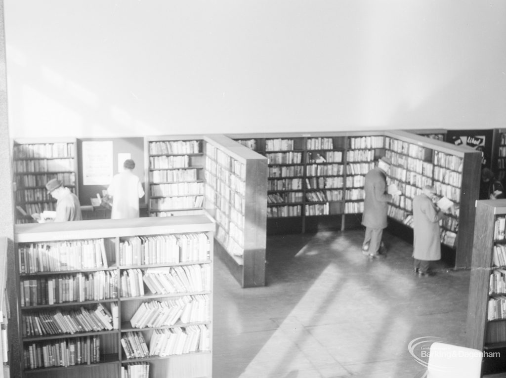 London Borough of Havering Central Library, Romford, showing part of the lending department, with bookcases and library users, 1967