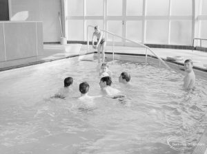 Swimming pool at Faircross Special School, Hulse Avenue, Barking, showing four boys close together awaiting ball, 1967