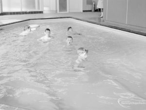 Swimming pool at Faircross Special School, Hulse Avenue, Barking, showing length of bath and five boys facing camera, 1967