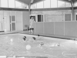 Swimming pool at Faircross Special School, Hulse Avenue, Barking, showing changing rooms, play balls and attendant, 1967