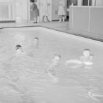Swimming pool at Faircross Special School, Hulse Avenue, Barking, showing boys with rubber ring, 1967
