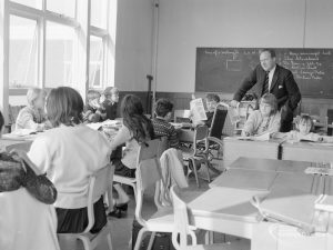 Faircross Special School, Hulse Avenue, Barking, showing classroom with children, and teacher at blackboard, 1967