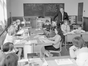 Faircross Special School, Hulse Avenue, Barking, showing classroom with teacher addressing pupils at desks, 1967