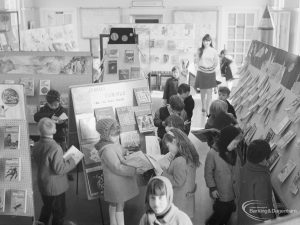 Barking Libraries Children’s Book Week at Valence House, Dagenham, showing children looking at display of books and member of staff, 1967