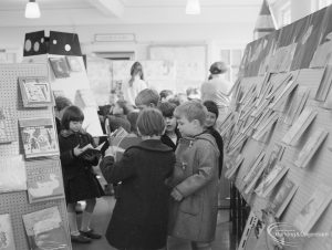 Barking Libraries Children’s Book Week at Valence House, Dagenham, showing group of boys between stands looking at display of books, 1967