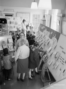 Barking Libraries Children’s Book Week at Valence House, Dagenham, showing adults and children looking at books, seen from above, 1967