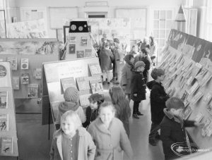 Barking Libraries Children’s Book Week at Valence House, Dagenham, showing a class of school children amongst the display stands, 1967