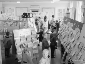 Barking Libraries Children’s Book Week at Valence House, Dagenham, showing a class of school children amongst the display stands, looking at the exhibited books, 1967