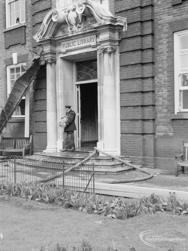 Fire at Barking Central Library, showing fireman at main entrance to building, 1967
