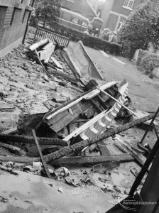Fire at Barking Central Library, showing part of the parapet and cornice lying in road, 1967