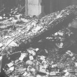 Fire at Barking Central Library, showing a charred major timber lying amidst other debris, 1967