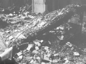 Fire at Barking Central Library, showing a charred major timber lying amidst other debris, 1967
