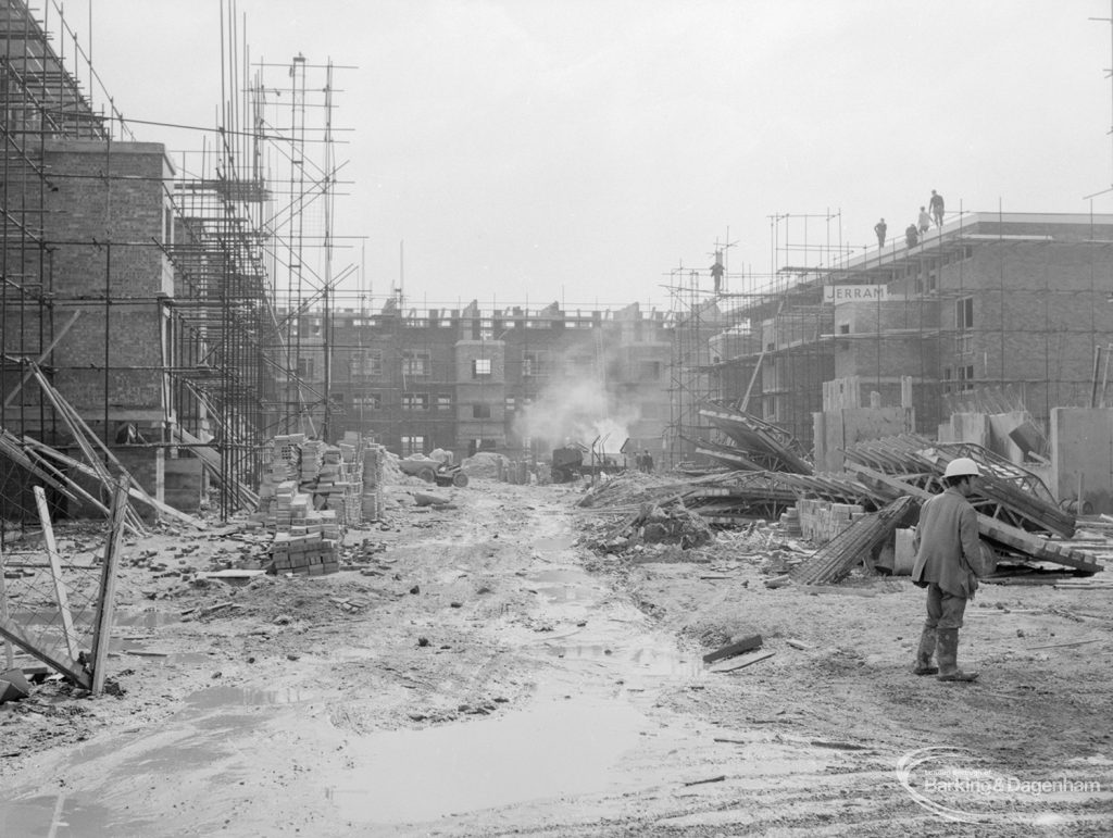Housing development, showing clearance and rubbish burning in half finished open ‘square’ between three new blocks of flats at Becontree Heath, 1967