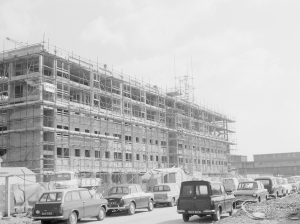 Housing development, showing new block of flats at Becontree Heath, with scaffolding and cars, 1967