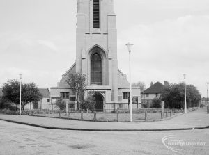 Lighting, showing locally designed lamp-posts flanking triangular green in front of Saint Alban’s Church, at junction of Urswick Road and Vincent Road, Dagenham, 1967