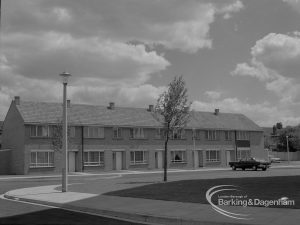 Housing development at John Burns Drive, showing row of neat houses facing a green with tree and new lamp post, 1967