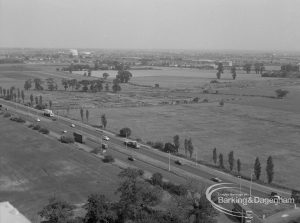 View from roof of Highview House, Hatch Grove, Chadwell Heath looking east-south-east towards open land across tree-lined Eastern Avenue, 1967