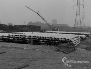 Sewage Works Reconstruction (Riverside Treatment Works) XVIII, showing small-bore pipes stacked on ground and crane, 1967