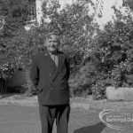 London Borough of Barking Libraries staff, showing retiring head janitor Mr Frank Walker against shrubs outside Valence House, Dagenham, 1967