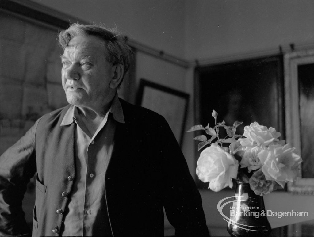 London Borough of Barking Libraries staff, showing retiring head janitor Mr Frank Walker with vase of roses he grew, 1967