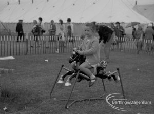 Dagenham Town Show 1967, showing young girl on rocking horse in children’s playground, 1967