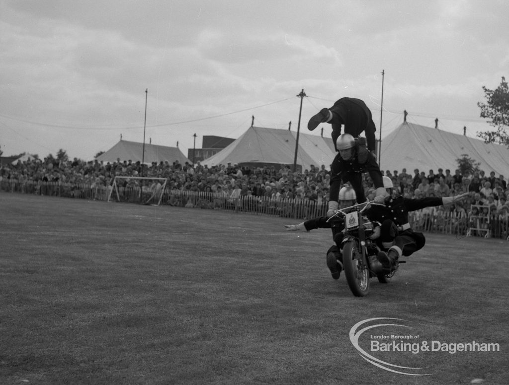 Dagenham Town Show 1967, showing Royal Marines Motorcycle Team Display, with group of marines balancing on motorbike in arena, 1967