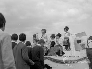 Dagenham Town Show 1967, showing beauty queens and attendants on float, with men watching at left, 1967