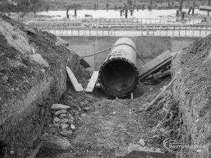 Sewage Works Reconstruction (Riverside Treatment Works) XIX, showing end of large pipe lying at bottom of trench, 1967