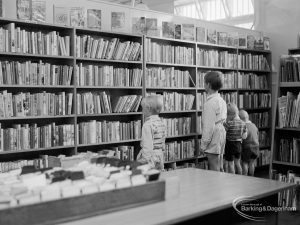 Children looking at bookshelves in temporary Barking Central Library in old Billiard Hall, off East Street, 1967