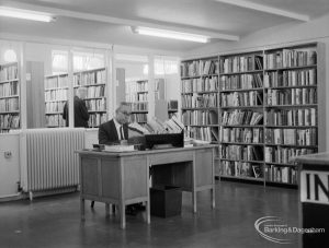 Mr McKenzie at his desk in temporary Barking Central Library in old Billiard Hall, off East Street, 1967