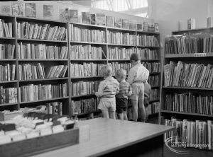 Family in Adult Lending Library in temporary Barking Central Library in old Billiard Hall, off East Street, 1967