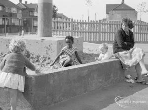 London Borough of Barking Works Department children’s playground in Oval Road North, Dagenham, showing mother watching children in sandpit, 1967