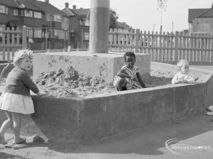 London Borough of Barking Works Department children’s playground in Oval Road North, Dagenham, showing three children in sandpit, 1967