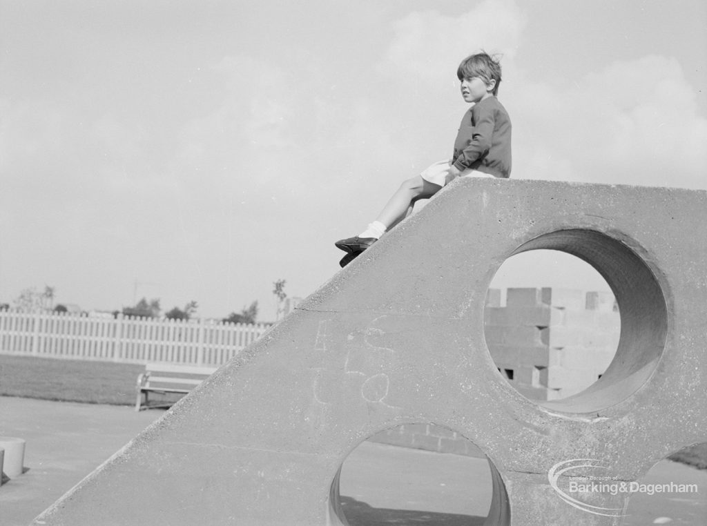 London Borough of Barking Works Department children’s playground in Oval Road North, Dagenham, showing child sitting and gazing from top of concrete slope, 1967