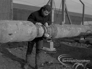 Sewage Works Reconstruction (Riverside Treatment Works) XX, showing man testing pipes welded together at Barking Creek outfall, 1967