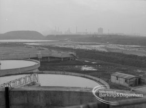 Sewage Works Reconstruction (Riverside Treatment Works) XX, showing  tanks and hill from south [east of EES12592], 1967
