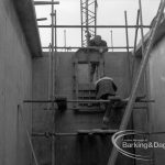 Sewage Works Reconstruction (Riverside Treatment Works) XX, showing workmen completing sluice gate in narrow rectangular tank, 1967