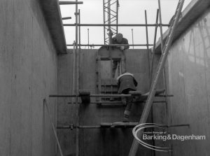 Sewage Works Reconstruction (Riverside Treatment Works) XX, showing workmen completing sluice gate in narrow rectangular tank, 1967