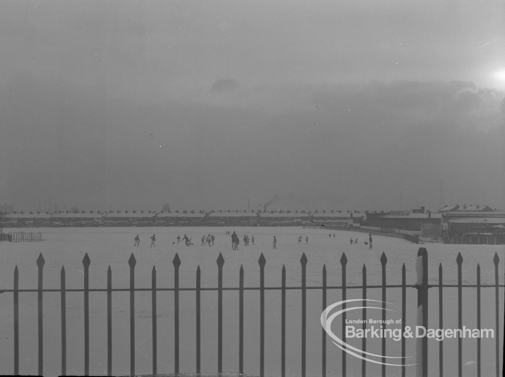 View of Old Dagenham Park under snow, showing children playing in distance, 1968