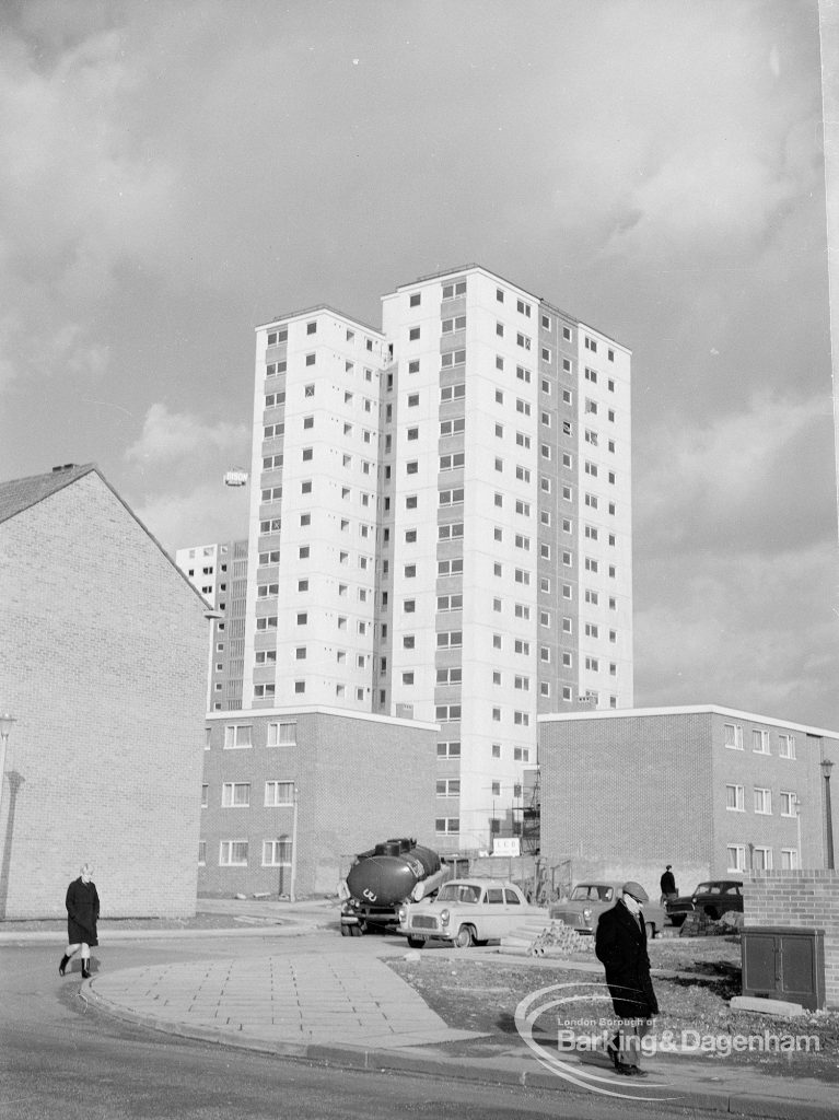 Housing, showing white block of flats rising above unfinished brick houses in Gascoigne area of Barking, 1968