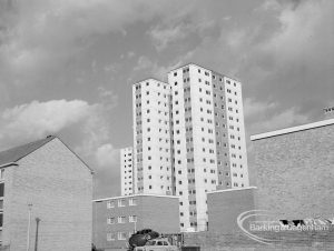 Housing, showing white block of flats rising above unfinished brick houses in Gascoigne area of Barking, 1968