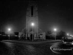 Street lighting at night in Dagenham, also showing Saint Alban’s Church tower at junction of Urswick Road and Vincent Road, 1968