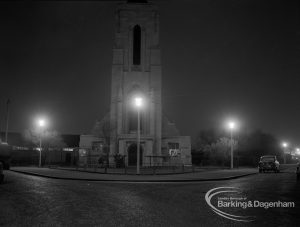 Street lighting at night in Dagenham, also showing Saint Alban’s Church tower at junction of Urswick Road and Vincent Road, 1968