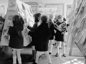 Barking Libraries Children’s Book Week [18th to 27th March] at Valence House, Dagenham, showing a crowded aisle with children looking at display of books, 1968